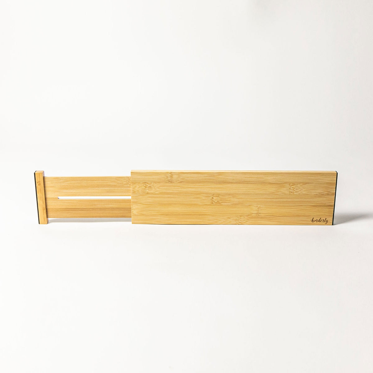 Horderly bamboo drawer divider installed in an organized drawer