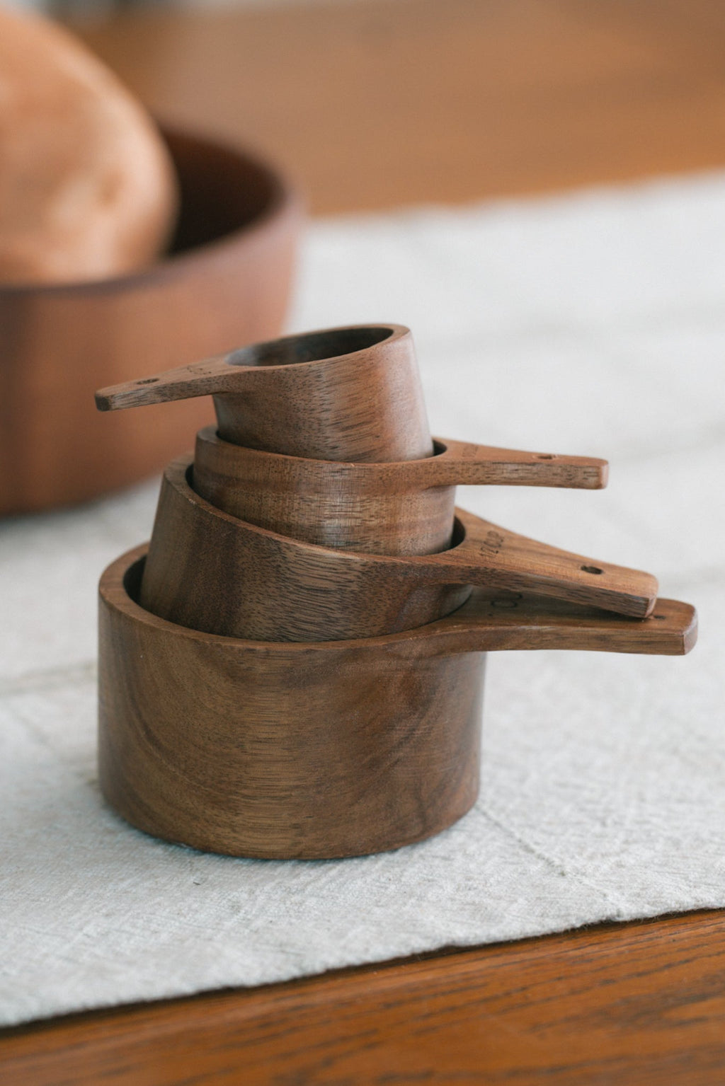 Wood measuring cup set with 1 cup, half cup, third cup and quarter cup sizes